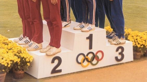 Men standing on an olympics stand