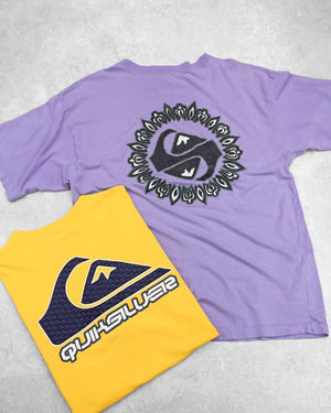 Purple and yellow t-shirts with Quiksilver logos on a light gray background