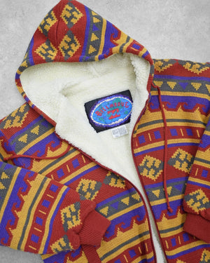 Colorful patterned vintage hoodie with a visible Billabong brand label on a gray background