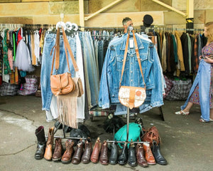 Vintage clothing and accessories on display at a flea market.
