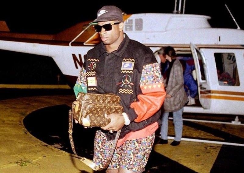 Person wearing a vintage Nike jacket in front of a helicopter